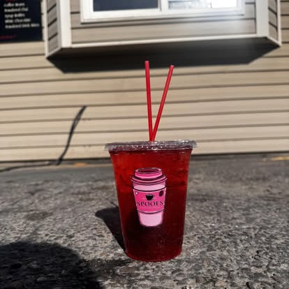 A berry-red iced refresher posed on the drive-thru sill